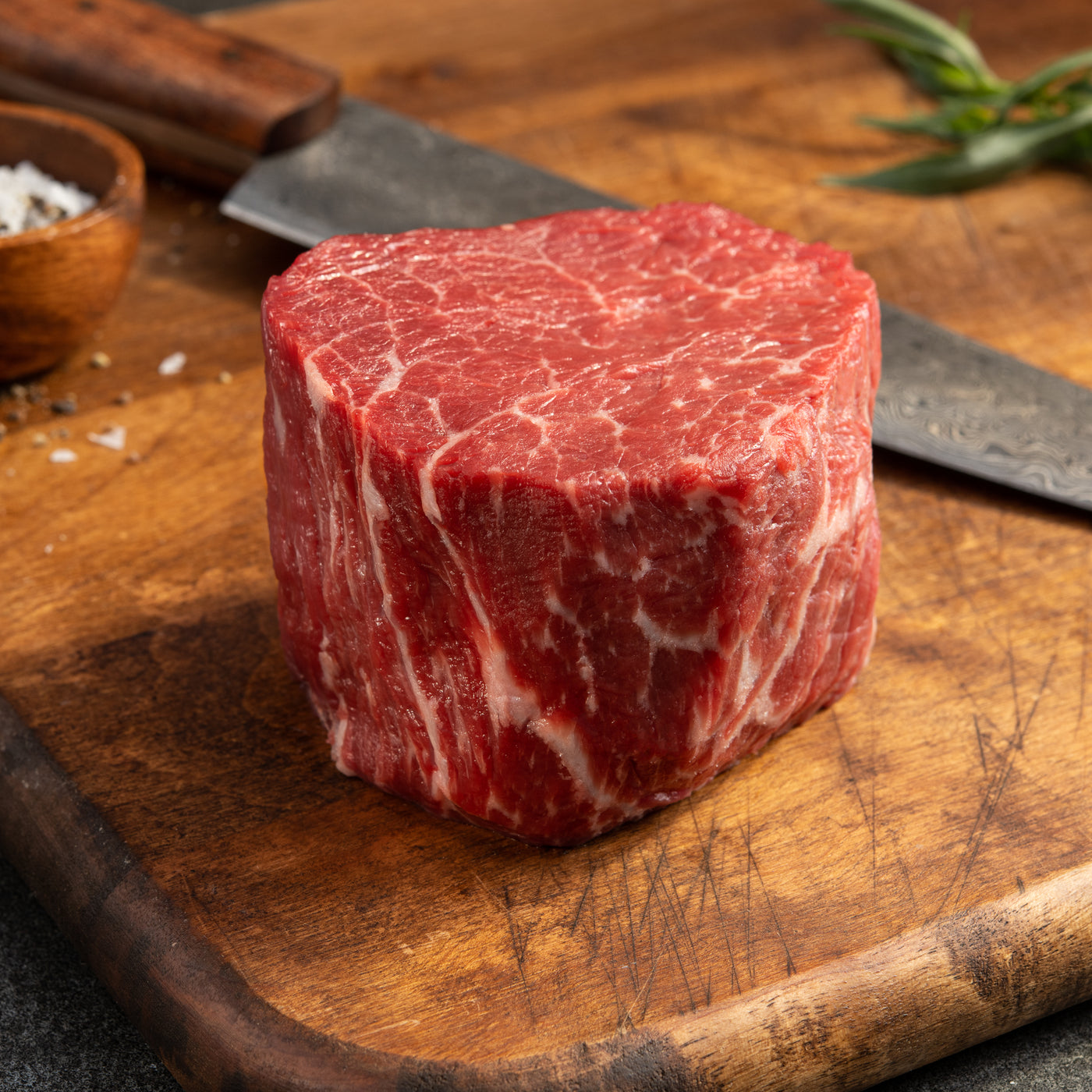 USDA Prime Filet Mignon raw cut with marbling on wood cutting board